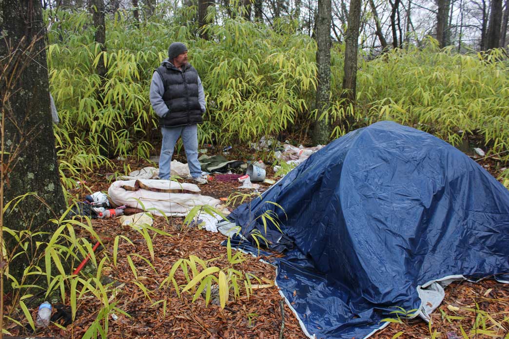 John looks at his tent, its contents strewn on the ground. Someone recently stole his heater out of the tent and threw the couple’s belongings outside. (Staff photo by Caitlin Owens)