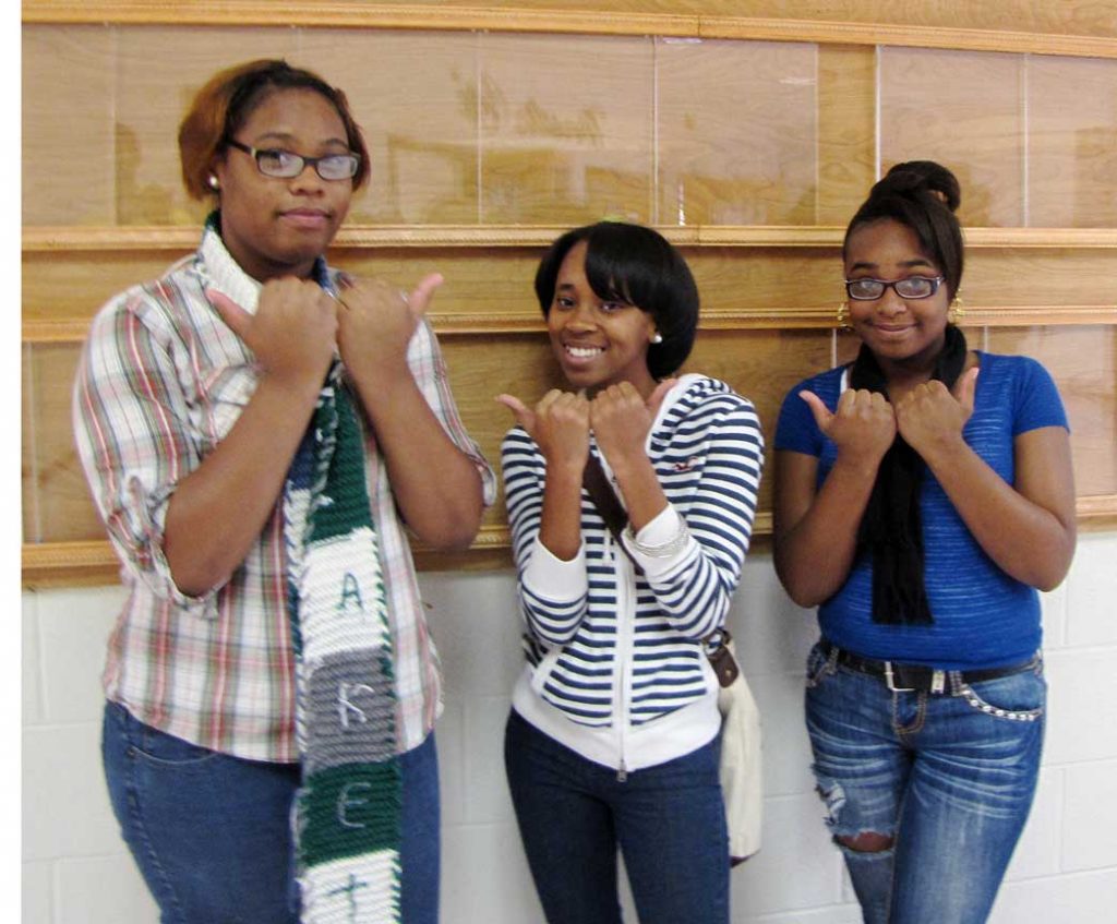 No, that is not a gang sign that (From left to right) Hillside New Tech students Cornelia Powell, Chantelle Love and Jazmyn George are holding up. It is the Bull City symbol. (Staff photo by Mahdiyah Al-askari)