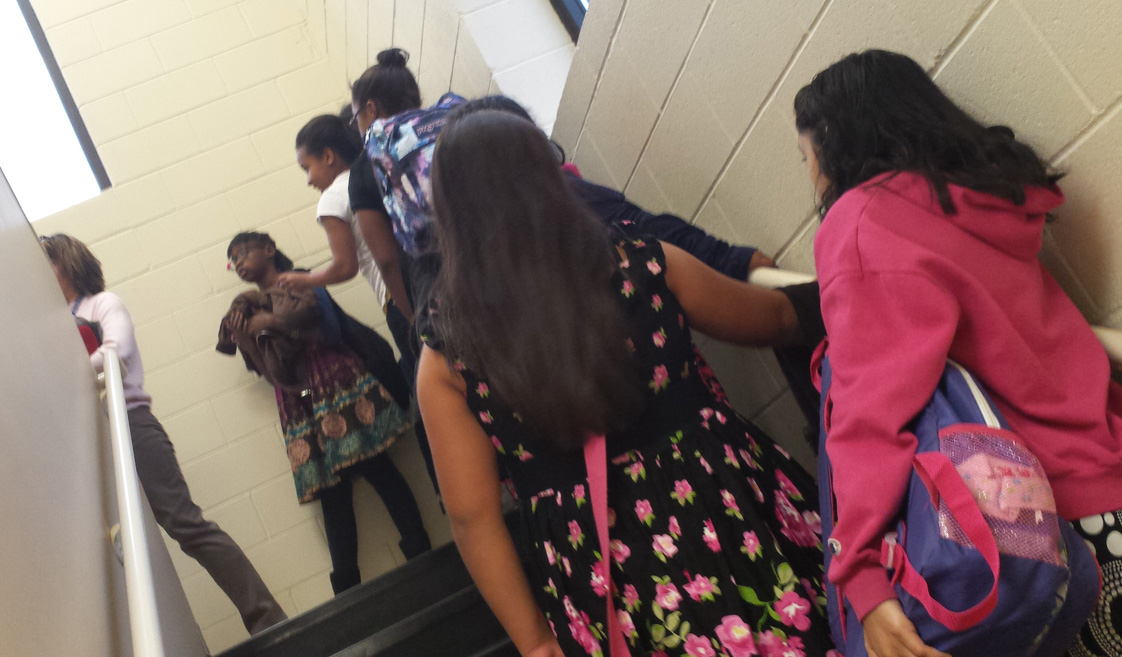 SMART students climb the stairs, eager to start another day of their program at Orange Grove Missionary Baptist Church. (Staff photo by Riyah Exum) 