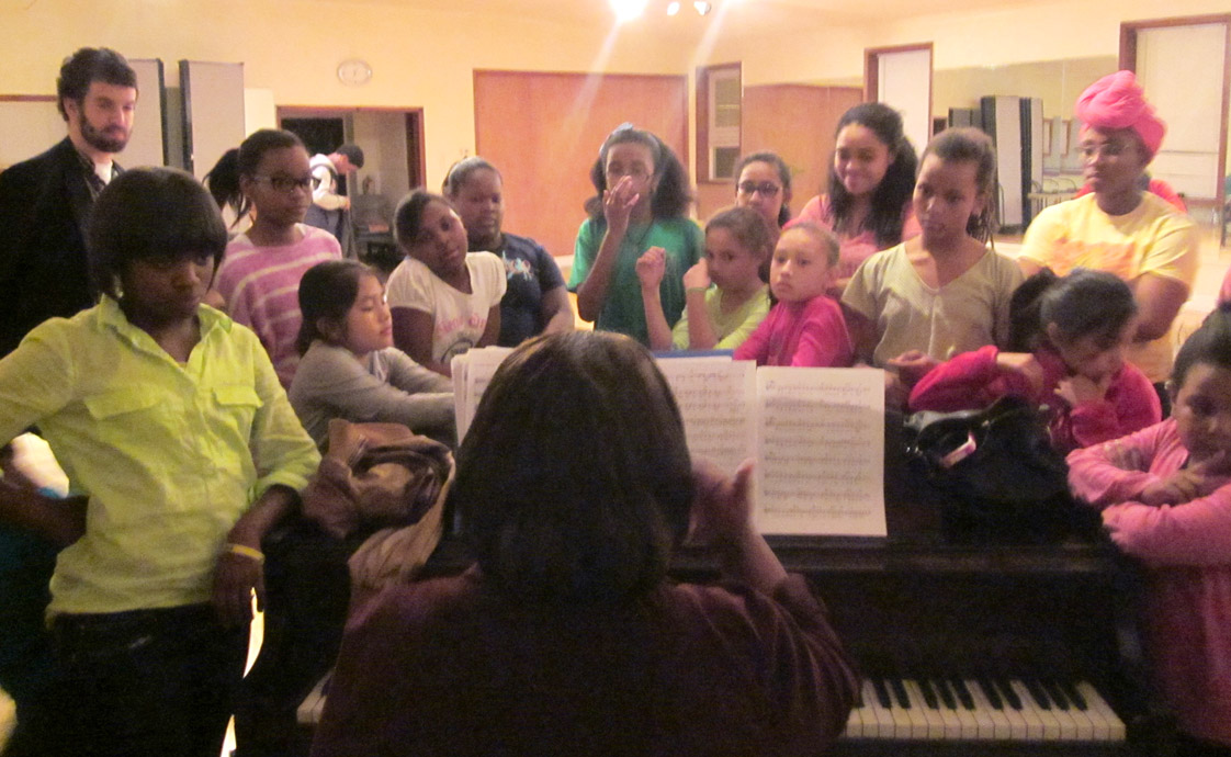 “Indigo Blue” actors and actresses gather round the piano as WCT’s vocal coach Paula Nunn harmonizes their voices together during rehearsal on Nov. 22.