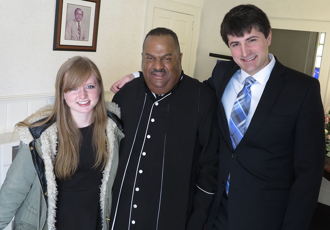The Reverend Michael D. Page of Antioch Baptist Church, flanked by VOICE Editor (fall 2014) Zoe Schaver, left, and VOICE co-editor (spring 2014) Zach Potter on MLK Sunday. (Staff Photo by Jock Lauterer)