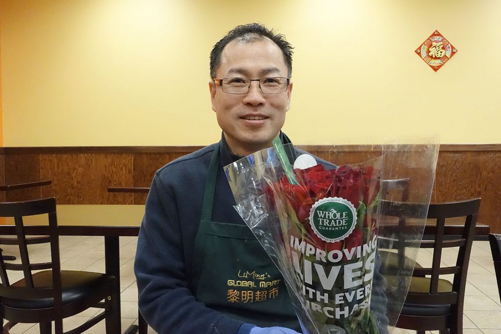 Zulin Yang, the general manager of LiMing’s Global Mart, is holding a bunch of red roses he prepares for his fiancée.