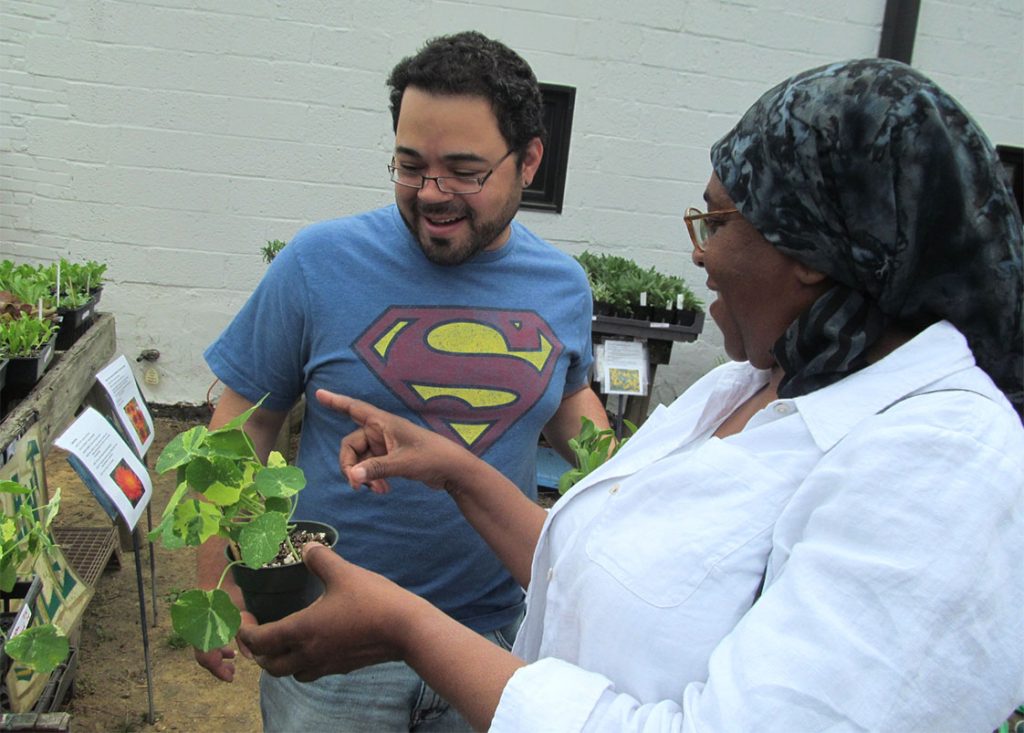 Karimah Abdusamad, right, giving Malcolm Goff, left, some pointers on getting his garden started.