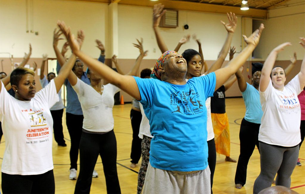     McDaniel Roberts leads the class in a stretching exercise. (Staff photo by Timothy Williams)