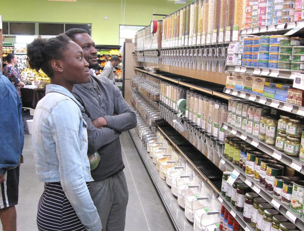 Father and daughter Adallia and Antwan Williams shop for tuna at the market’s grand opening.