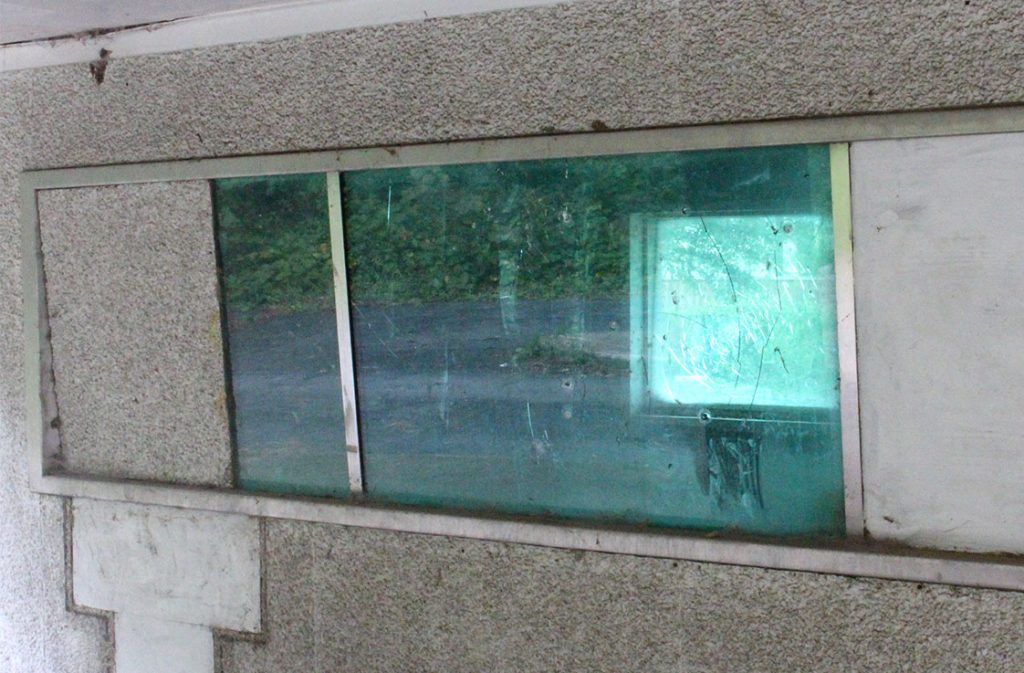 The drive-through window of the former Wachovia bank branch at Angier and Driver Streets shows the signs of crime and neglect. (Staff photo by Eric O’Neal)