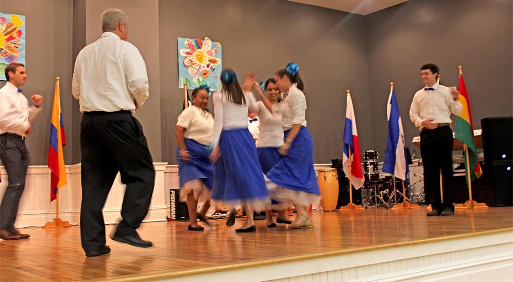 Principal Mark Bailey, pictured in the far left, dances with faculty during the Maureen Joy Charter School’s Hispanic Heritage event. (Staff photo by Eric O’Neal)