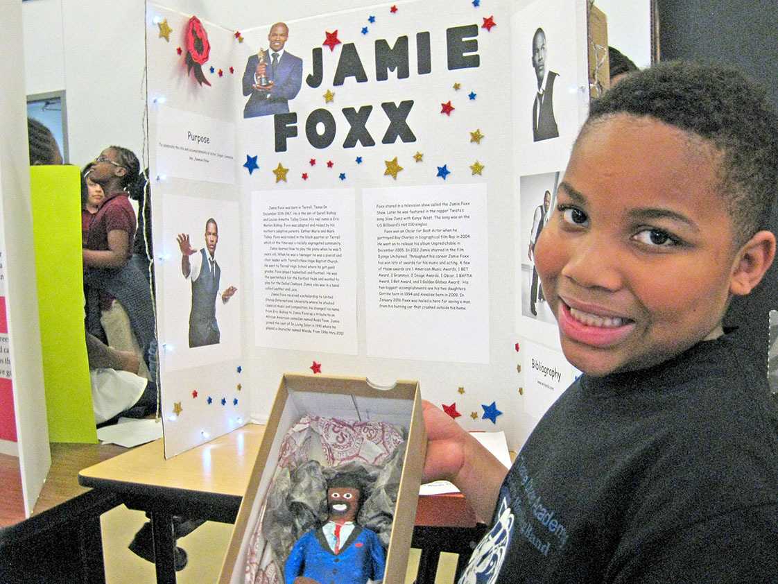 Kamauri Hinton shows off his Jamie Foxx clay figure along with his poster. (Staff photo by Candice Craig)