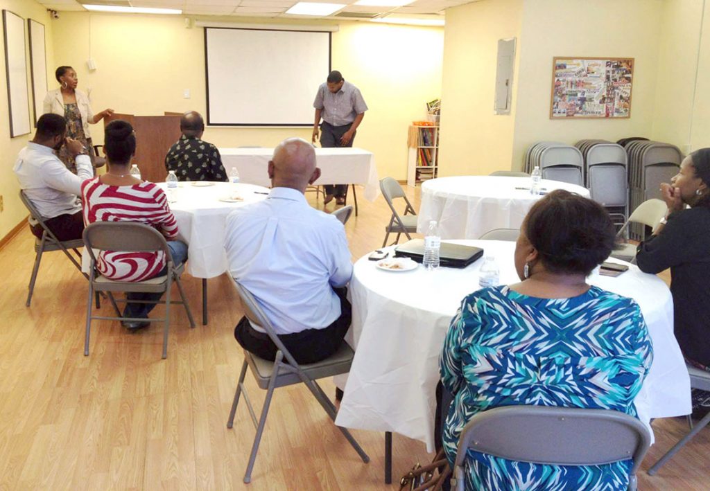 The Reeds (standing in background) address an open house meeting of the Durham Black Business Chain at the Nu Development Community Center. (Staff photo by PYO interns Kristine Royster and Christian Lawrence)