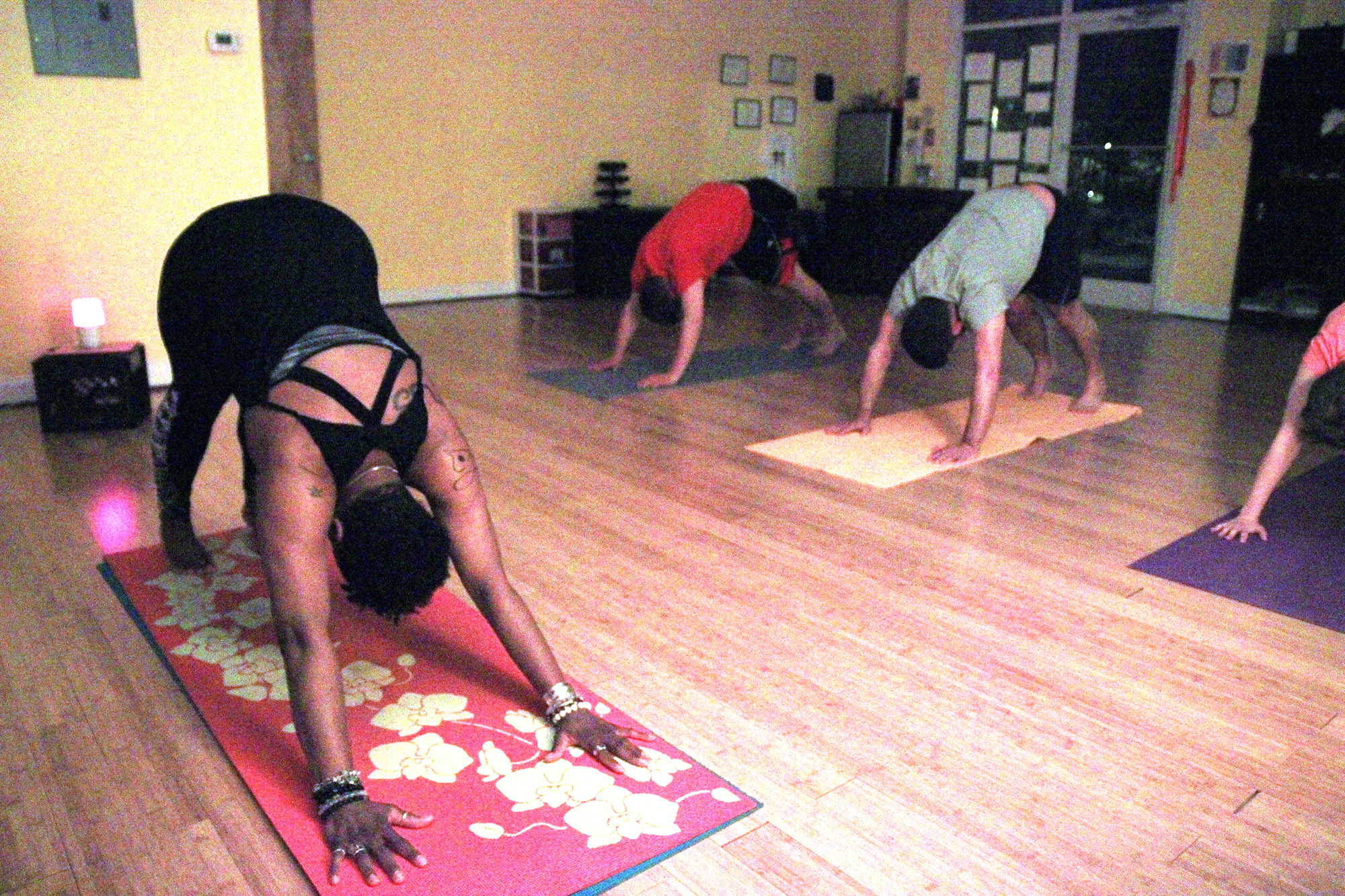 Ingrid Saddler-Walker demonstrates a common inversion yoga pose, Downward Facing Dog. This pose is great for increasing blood flow to the brain and eyes. It stimulates the nervous system to help with memory and concentration. (Staff photo by Diamond Gwynn)