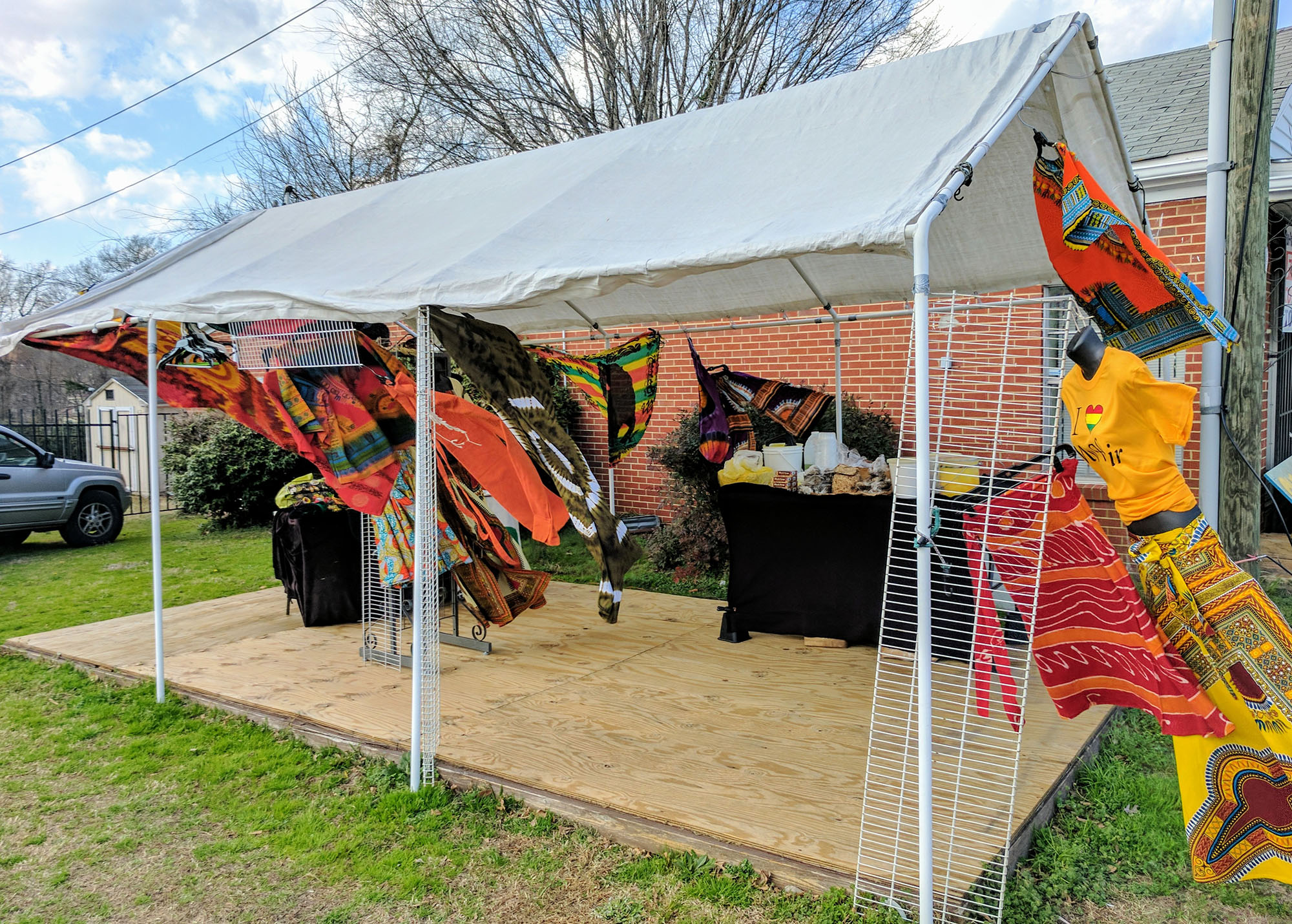 The wind whips a tent set up for the pop-up market "Tushea," a business that sells garments and African soaps made with shea butter. (Staff photo by Brian Shurney)
